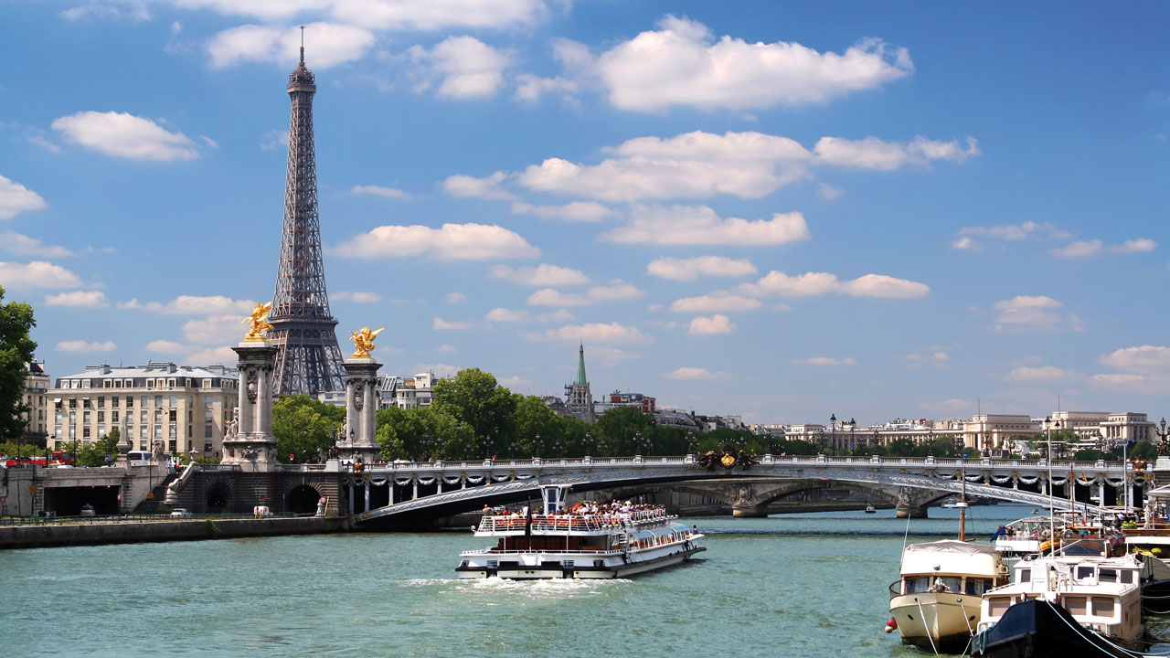 Blick auf Boote auf der Seine in Paris mit dem Eifelturm im Hintergrund
